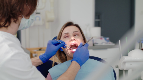 A woman has an annual dental check-up in dentist surgery.