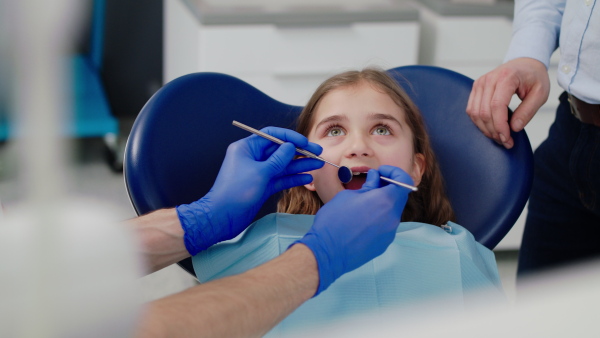 A dental check-up of a small girl in dentist surgery, midsection.