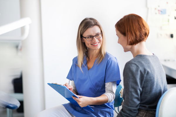 A woman has an annual dental check-up in dentist surgery.