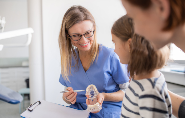 A small girl, mother and dentist in surgery, a dental checkup.