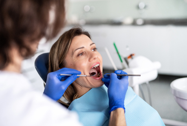 A woman has an annual dental check-up in dentist surgery.