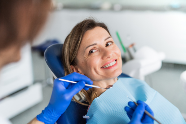 A woman has an annual dental check-up in dentist surgery.