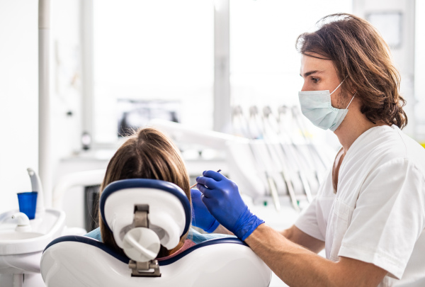 A dental check-up of unrecognizable patient in dentist surgery.