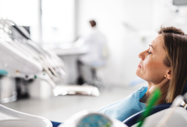 A woman has an annual dental check-up in dentist surgery.