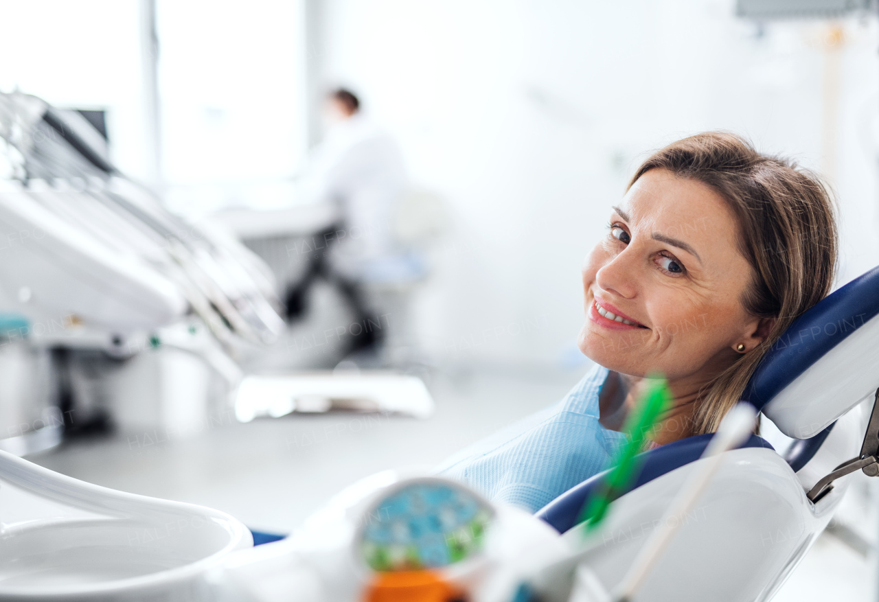 A woman has an annual dental check-up in dentist surgery.