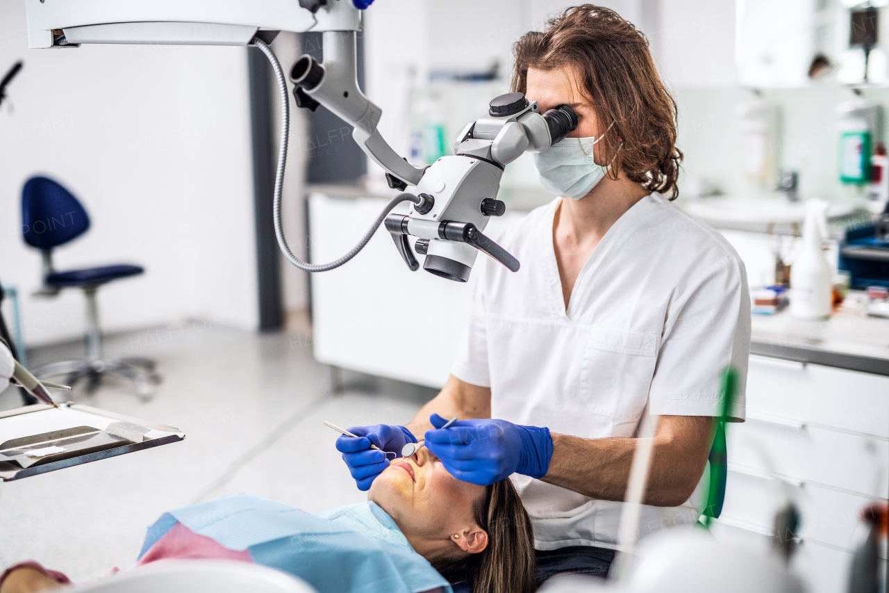 A woman has an annual dental check-up in dentist surgery.