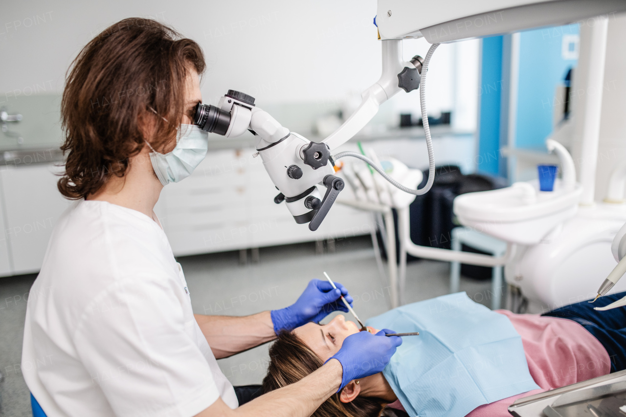 A woman has an annual dental check-up in dentist surgery.