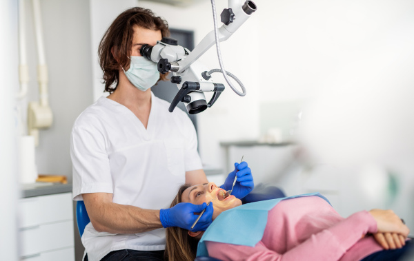 A woman has an annual dental check-up in dentist surgery.