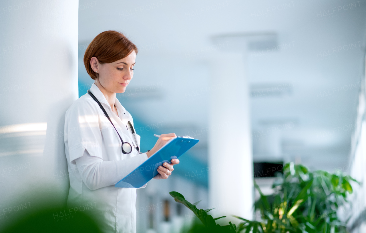 A portrait of woman doctor standing in hospital. Copy space.