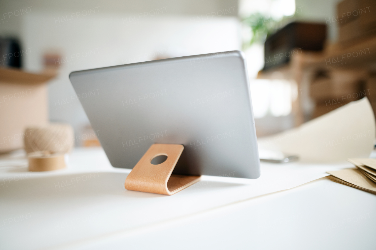 A close-up of tablet on stand on desk in office.