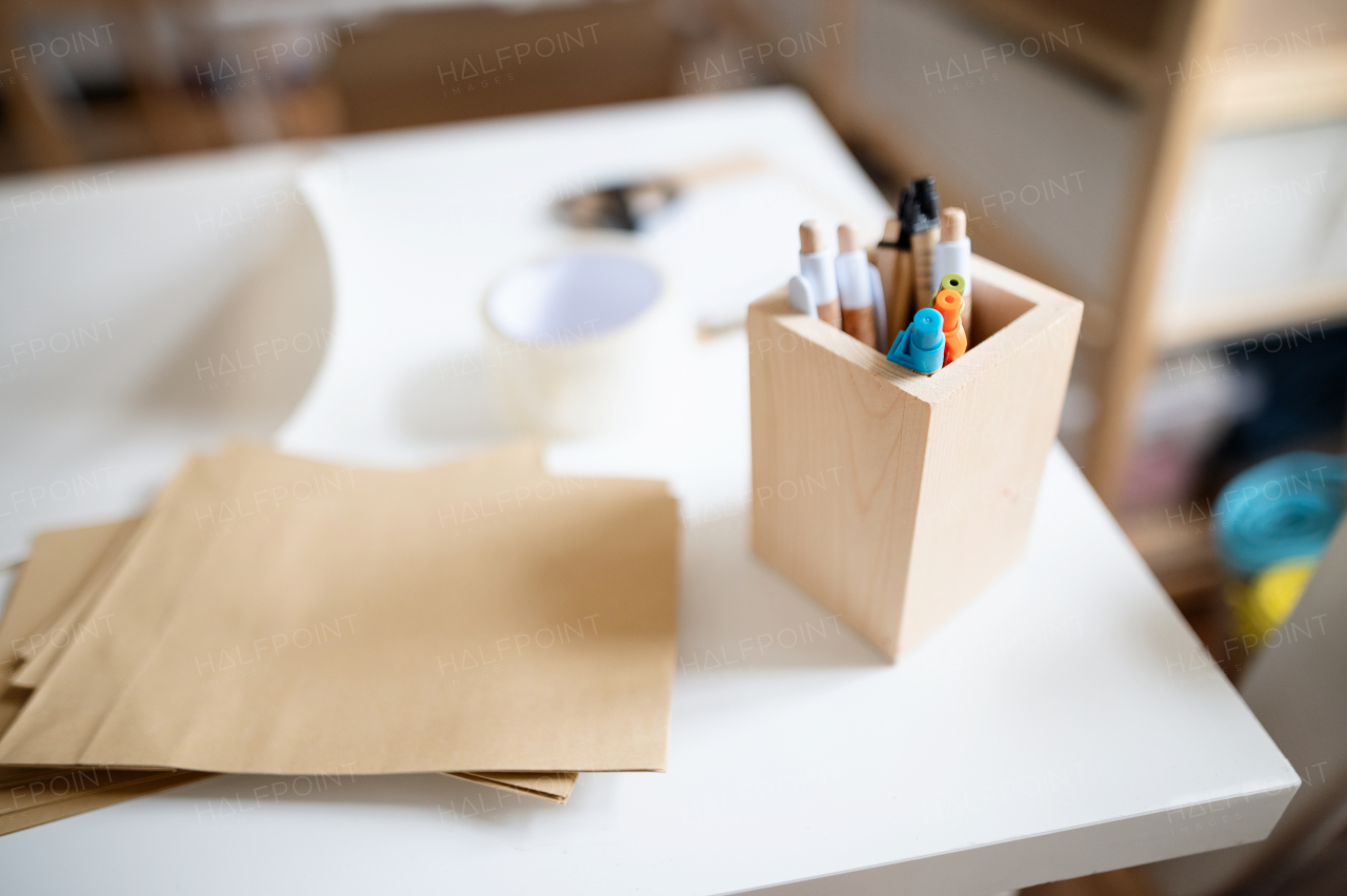 A wooden box container holder with pens on desk, natural decor concept.