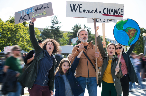 People with placards and posters on a global strike for climate change, shouting.