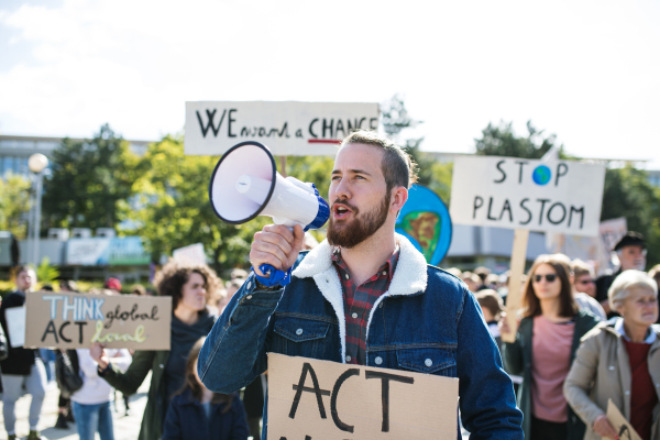 People with placards and amplifier on a global strike for climate change.