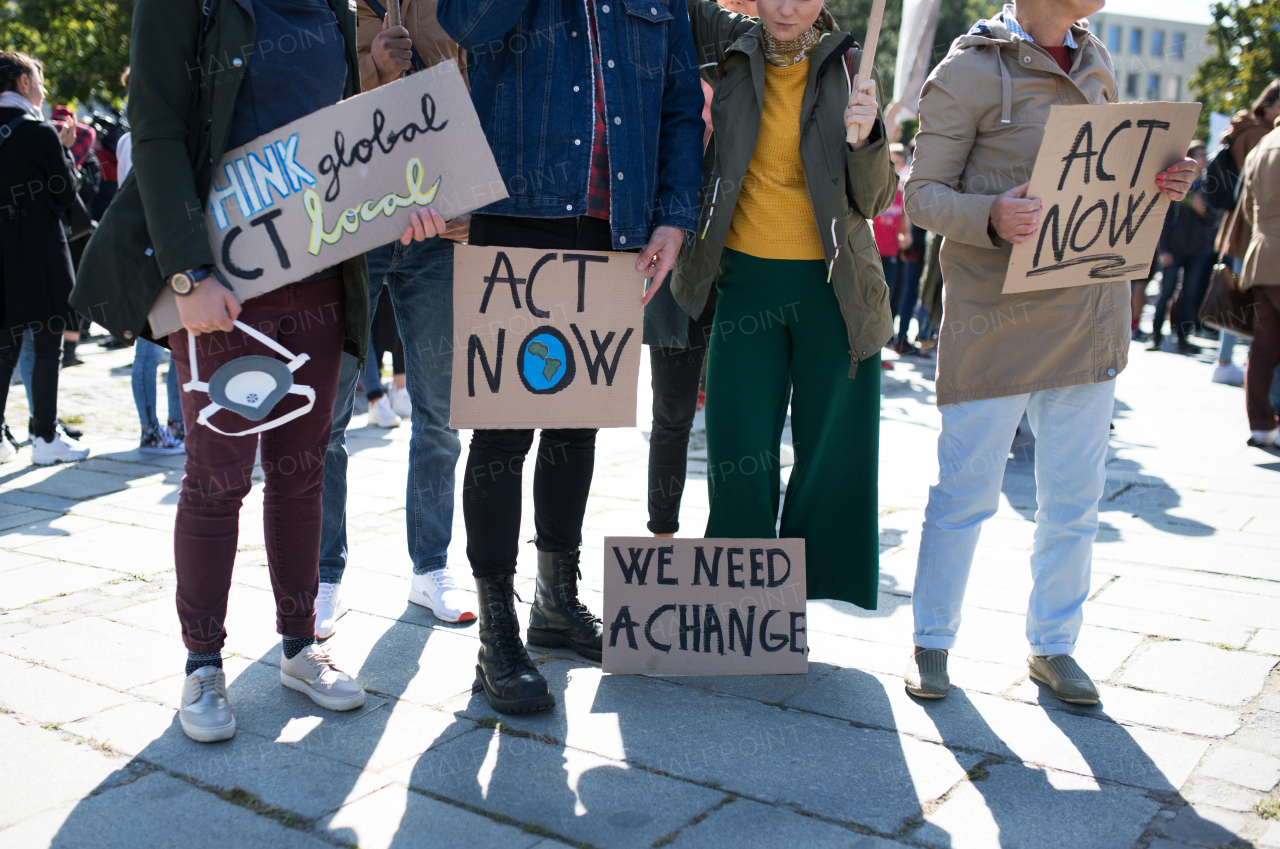 People with placards and posters on a global strike for climate change, midsection.