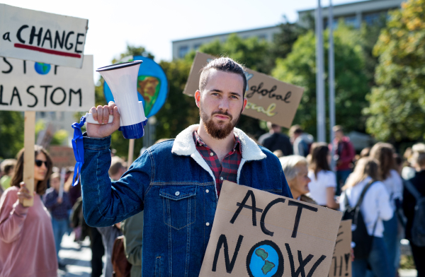 A man with placards and amplifier on global strike for climate change.