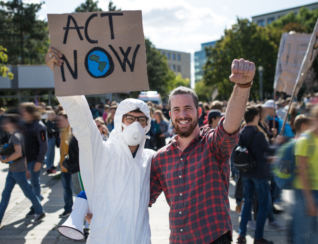 A people with placards and protective suit on a global strike for climate change.