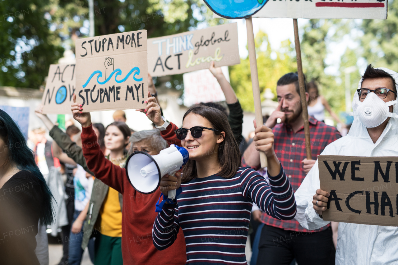 People with placards and amplifier on a global strike for climate change.