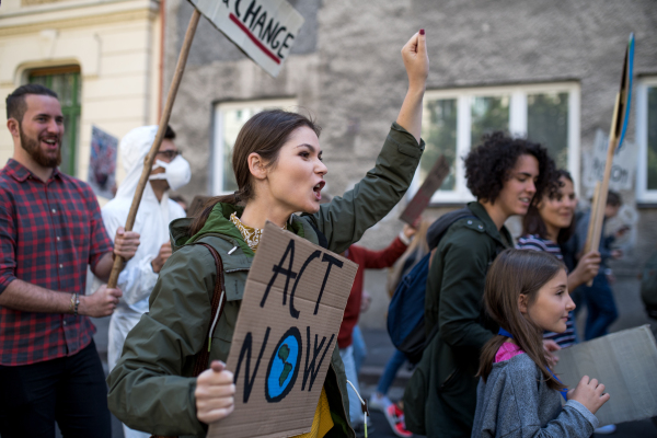 People with placards and posters on a global strike for climate change, shouting.