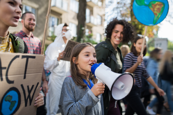 A small child with amplifier on global strike for climate change