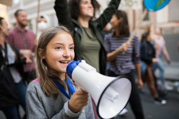 A small child with amplifier on global strike for climate change