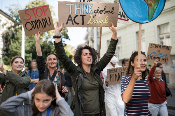 People with placards and posters on a global strike for climate change, shouting.