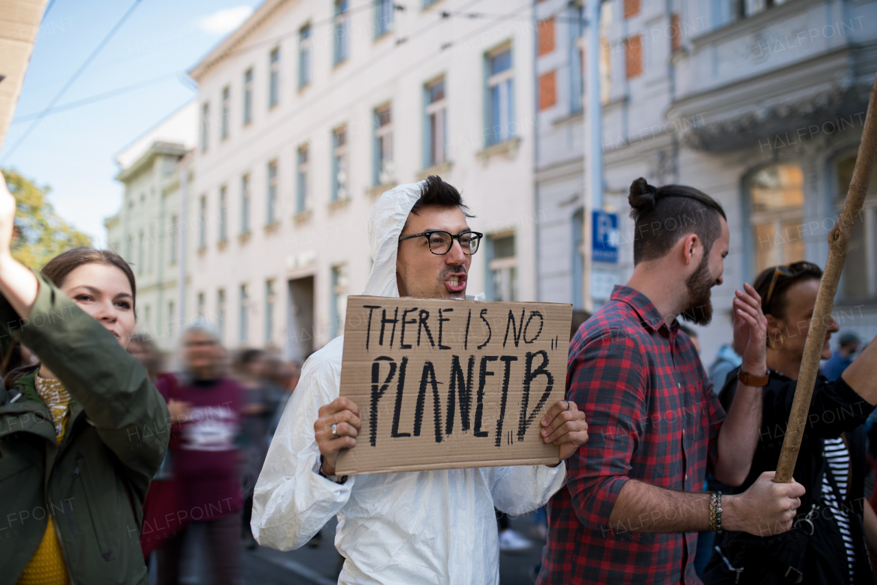 People with placards and protective suit on a global strike for a climate change.