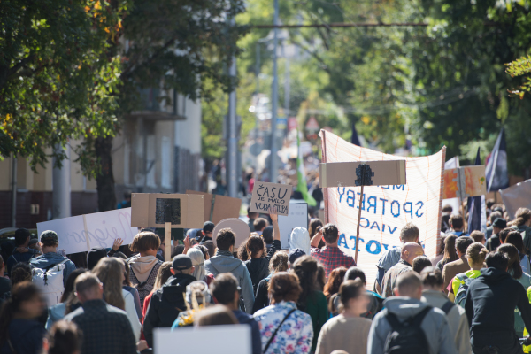 A rear view of people with placards and posters on global strike for climate change.