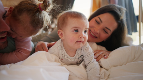 A happy young family with small children having fun in cabin on holiday.