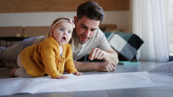 A young father enjoying time together with baby girl at home.