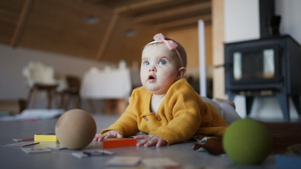 A little baby lying on floor and playing.