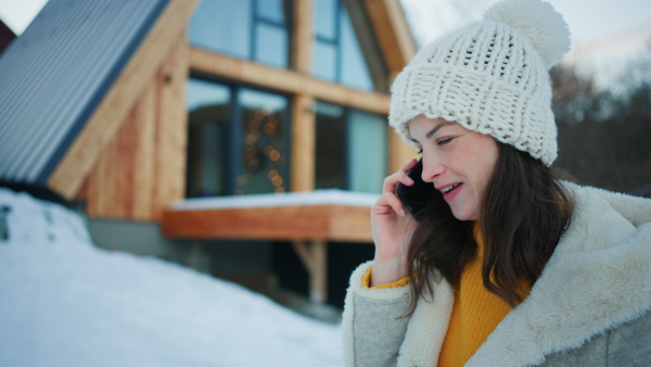 A young woman calling on phone in winter holidays