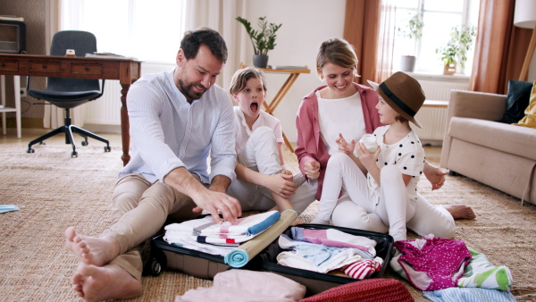 A beautiful family packing and making preparations for vacation.