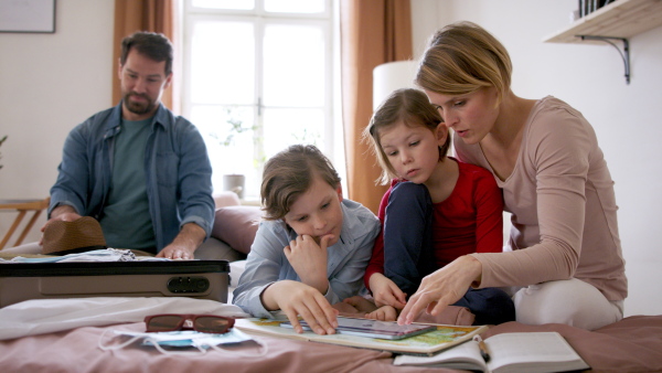 A beautiful family making preparations for vacation on tablet.