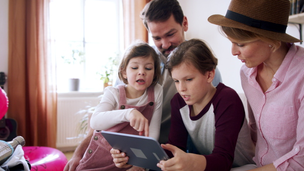 A beautiful family making preparations for vacation on tablet.