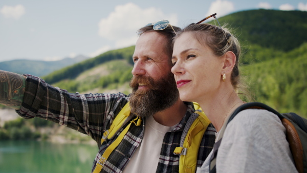 A happy mature couple in love hiking in nature.