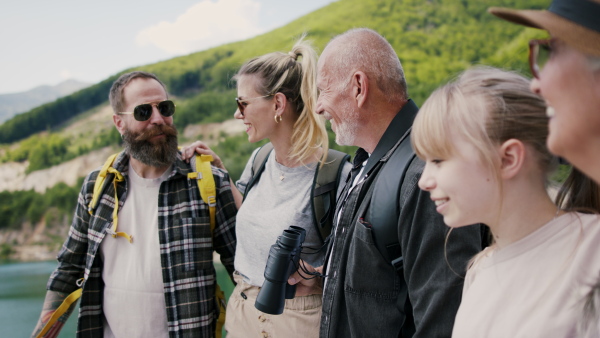 A happy multigeneration family on hiking trip on summer holiday.