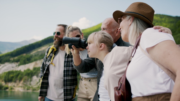 A happy multigeneration family on hiking trip on summer holiday.