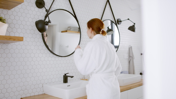 Beautiful couple in bathroom getting ready for work in the morning.