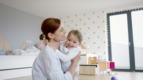 Busy mother preparing her daughter for kindergarten.