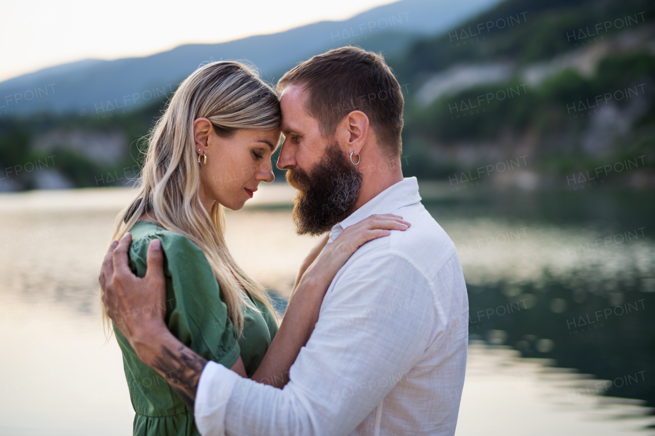 Portrait of happy mature couple in love hugging in nature.