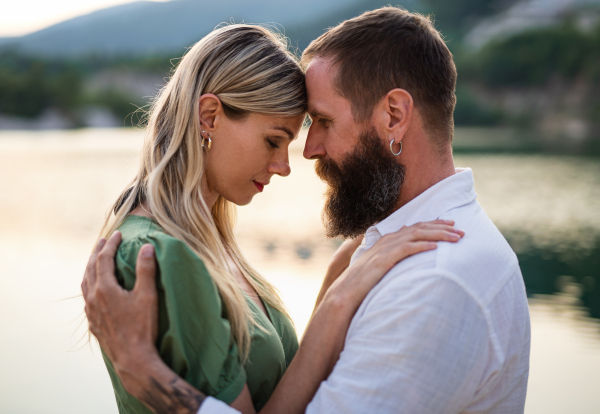 Portrait of happy mature couple in love hugging in nature.