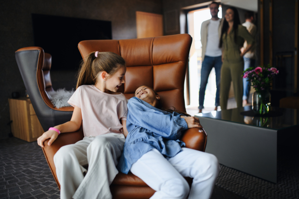 A happy two sisters with parents enjoying time at luxury hotel, summer holiday.