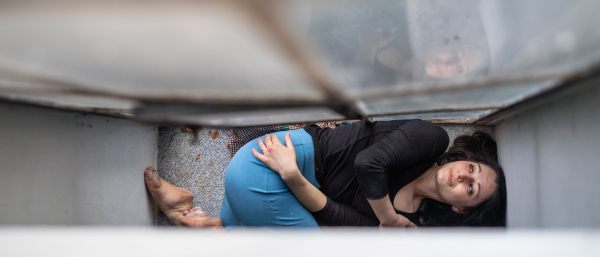 Top view portrait of lonely woman lying on old and dirty window sill, solitude, mental health and depression concept.