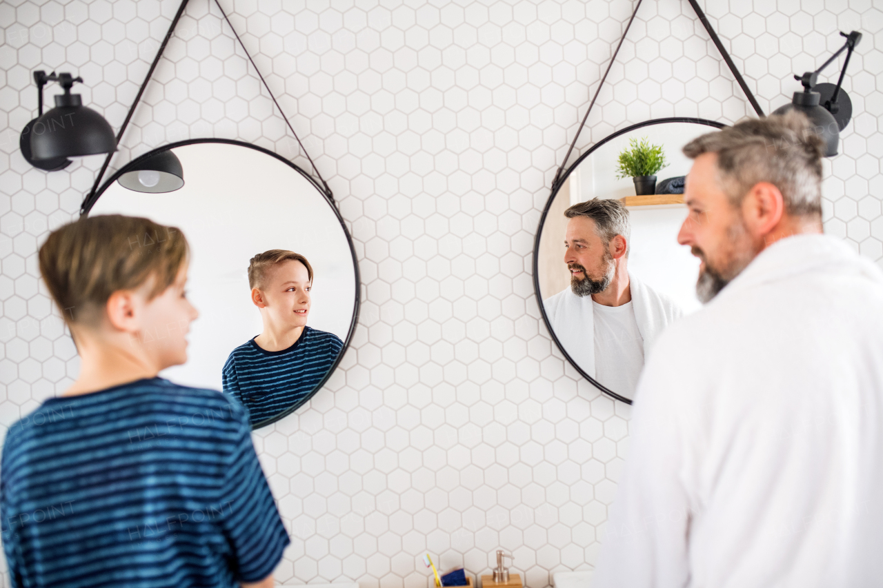 A mature father with small in the bathroom in the morning, talking.