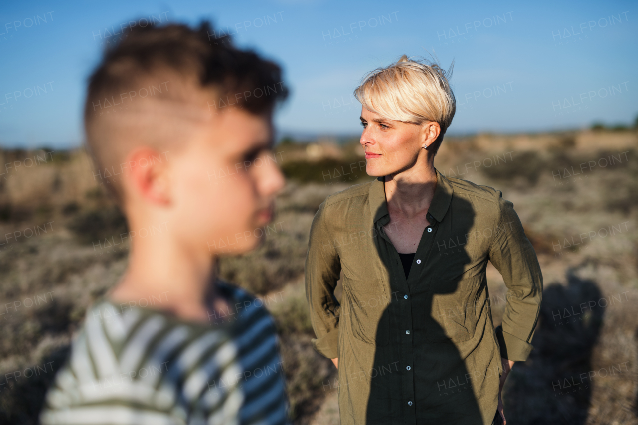 Portrait of mother with son standing outdoors in nature in the Mediterranean.