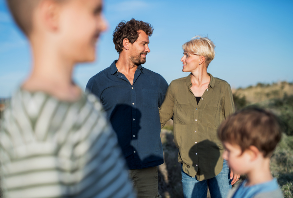 Young family with two small children standing outdoors in nature in Greece.