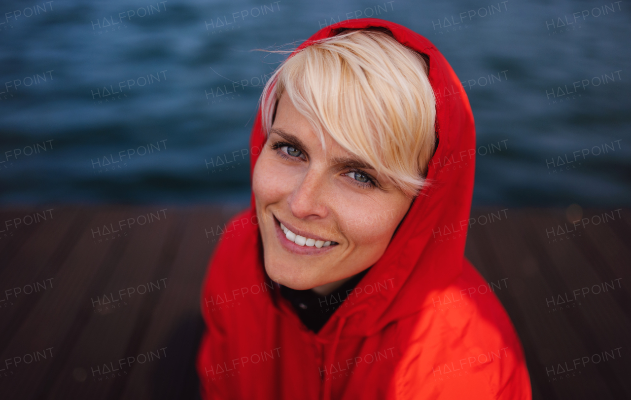 A close-up portrait of young woman standing outdoors on beach.