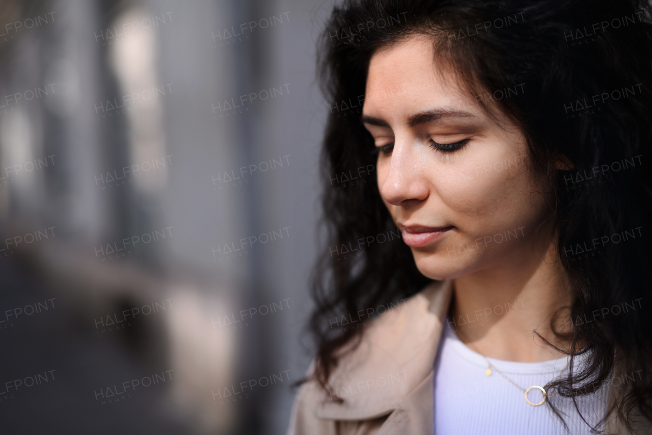 A close-up portrait of young business woman standing outdoors on street in city. Copy space.