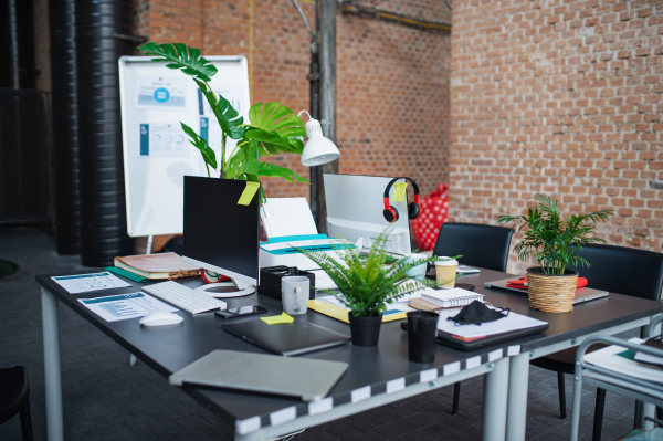 Desks with computers and other office supplies, a coworking concept.