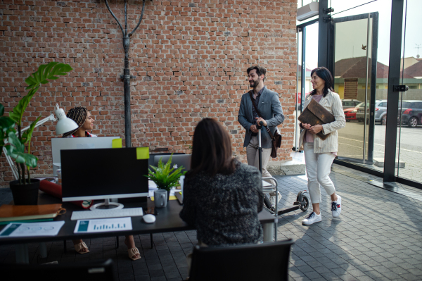 Young and old businesspeople working in an office, coworking and eco commuting concept.